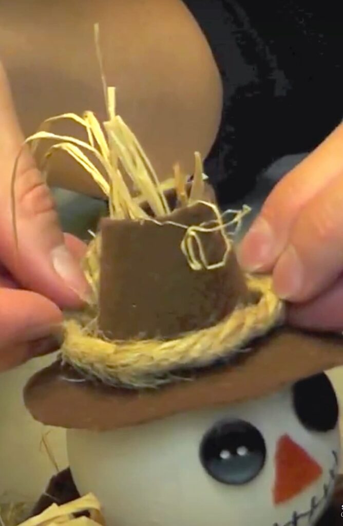 Adding rope to the scarecrow hat