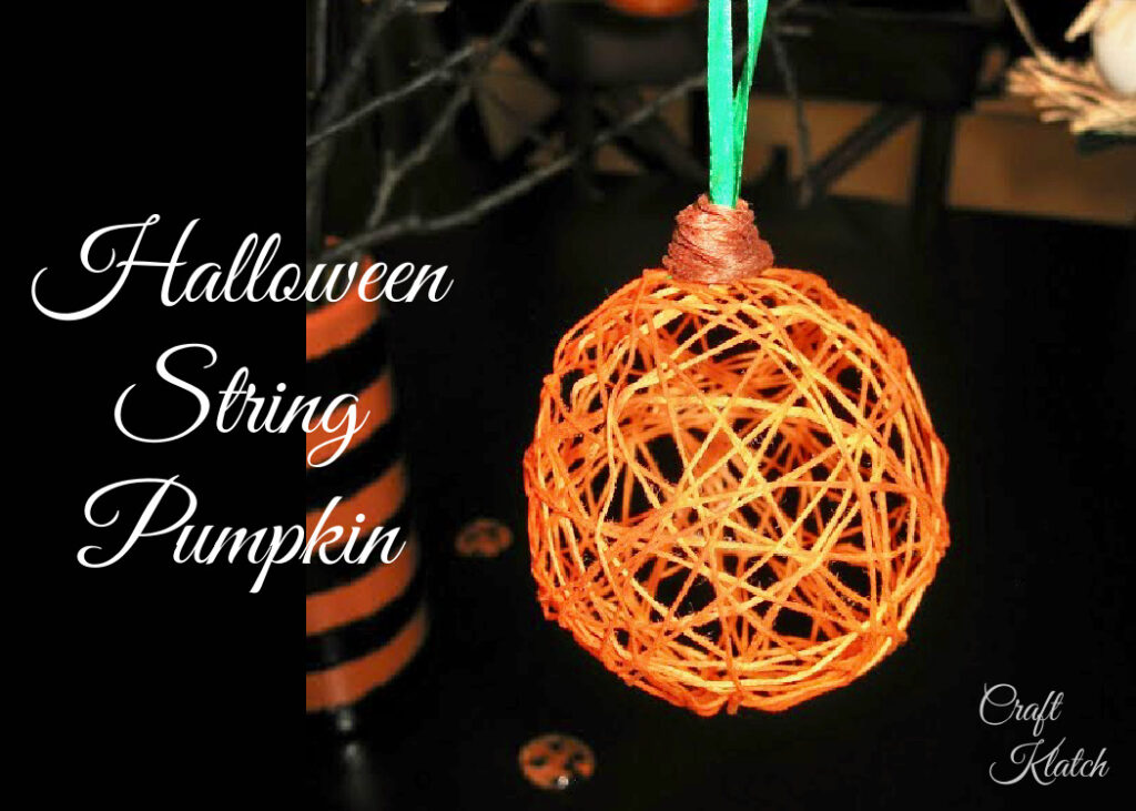 String pumpkin Halloween decoration hanging from a branch