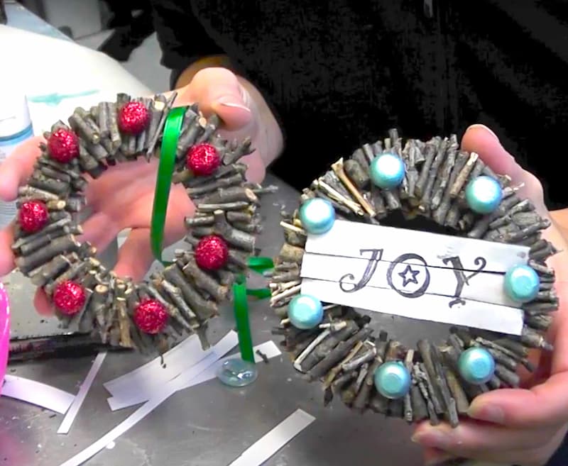 Holding both twig wreath ornaments