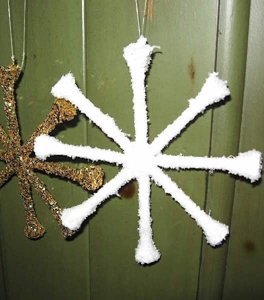 Snowflake ornament hanging with glitter star ornament