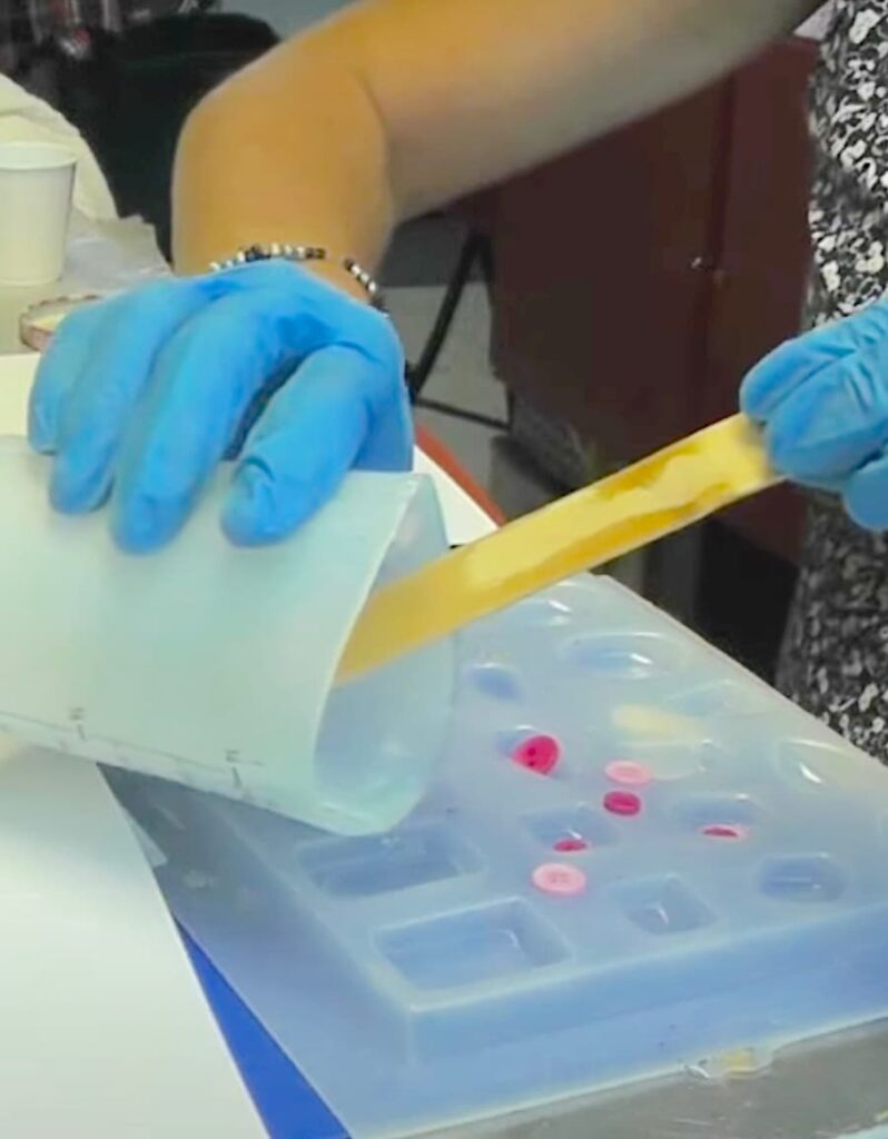 pouring resin into jewelry mold