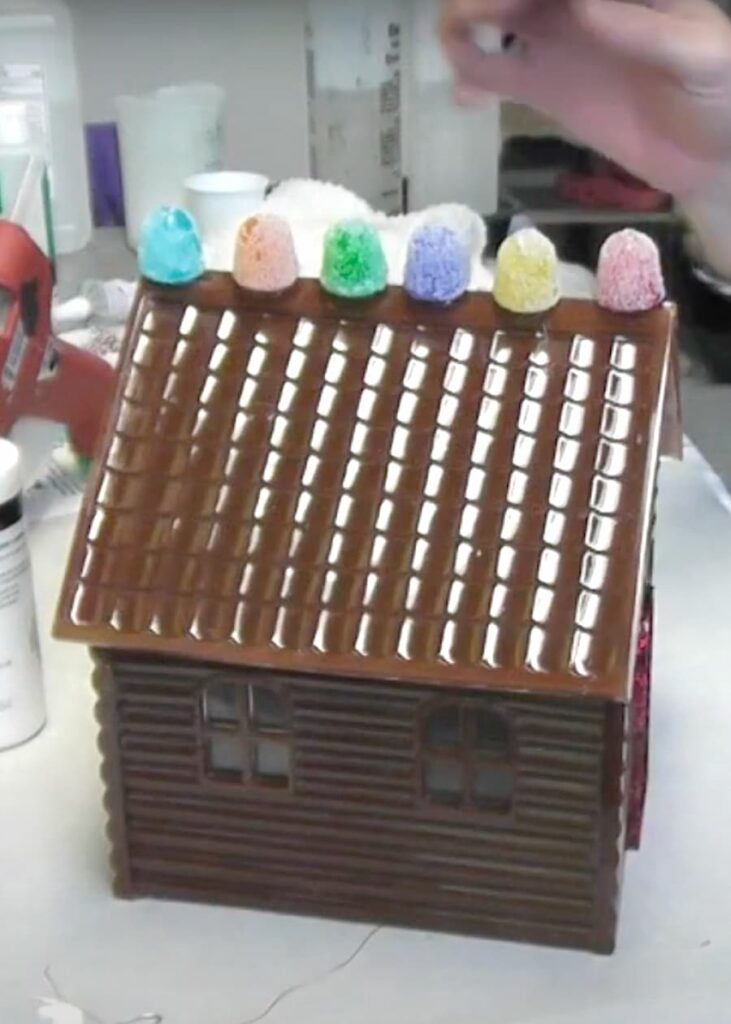 Gumdrops glued to the top of a gingerbread house peak