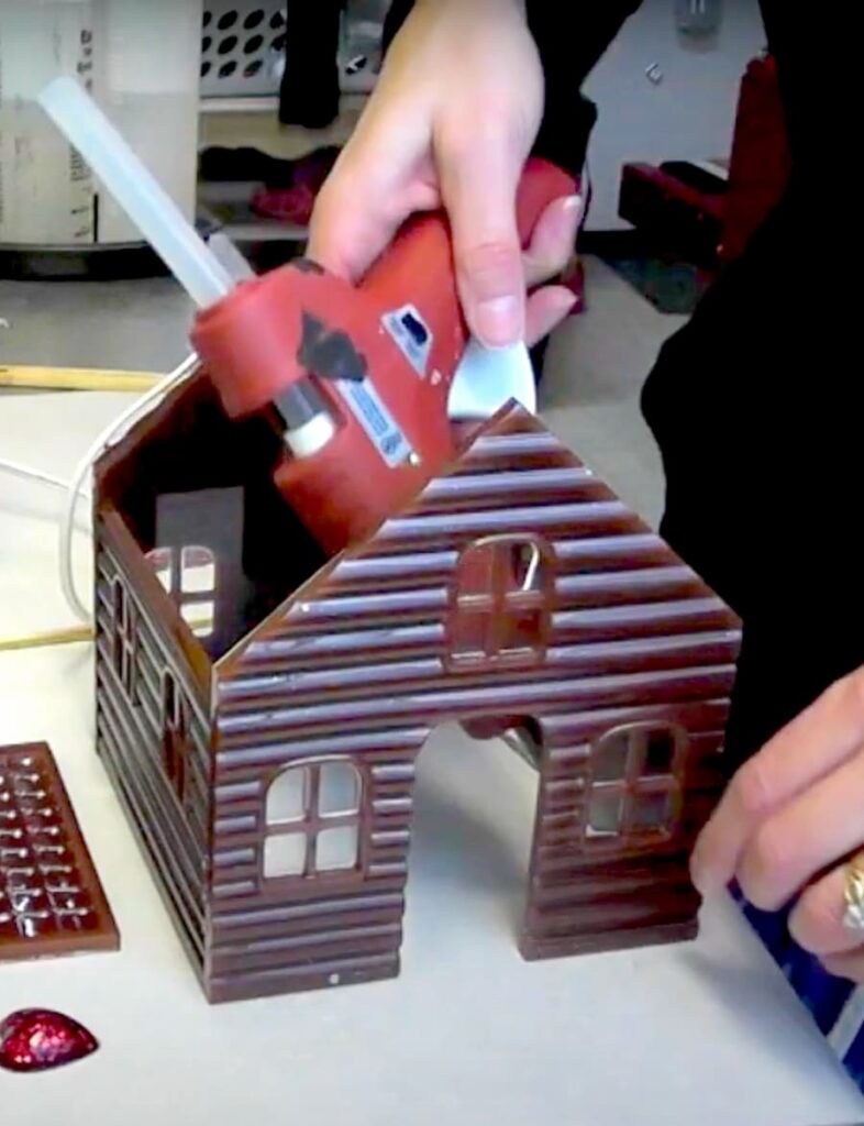 how to make a gingerbread house for Christmas using hot glue to attach the walls