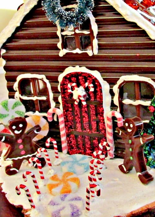 Close up of resin gingerbread house with gingerbread men, candy canes and candy