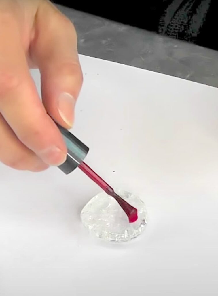 brushing nail polish on glass cracked gems