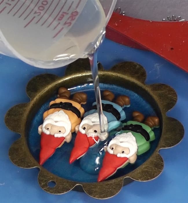 Pouring resin on gnome pendant