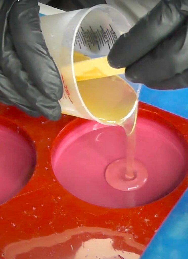 Pouring resin into cavity of coaster mold