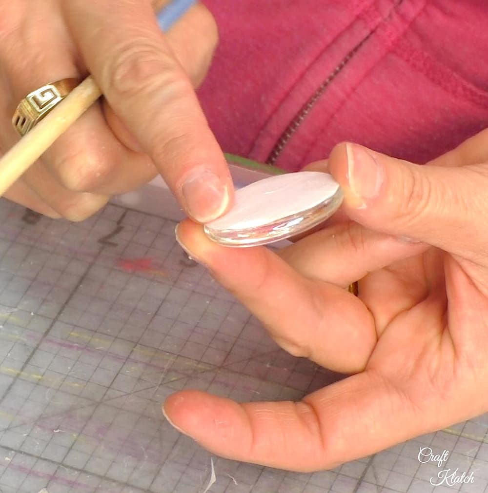  Use finger to press paper onto back of glass stone