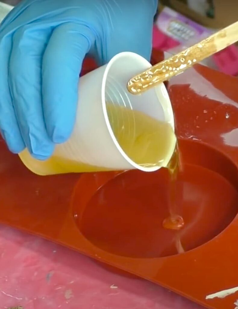 Pouring resin into coaster mold