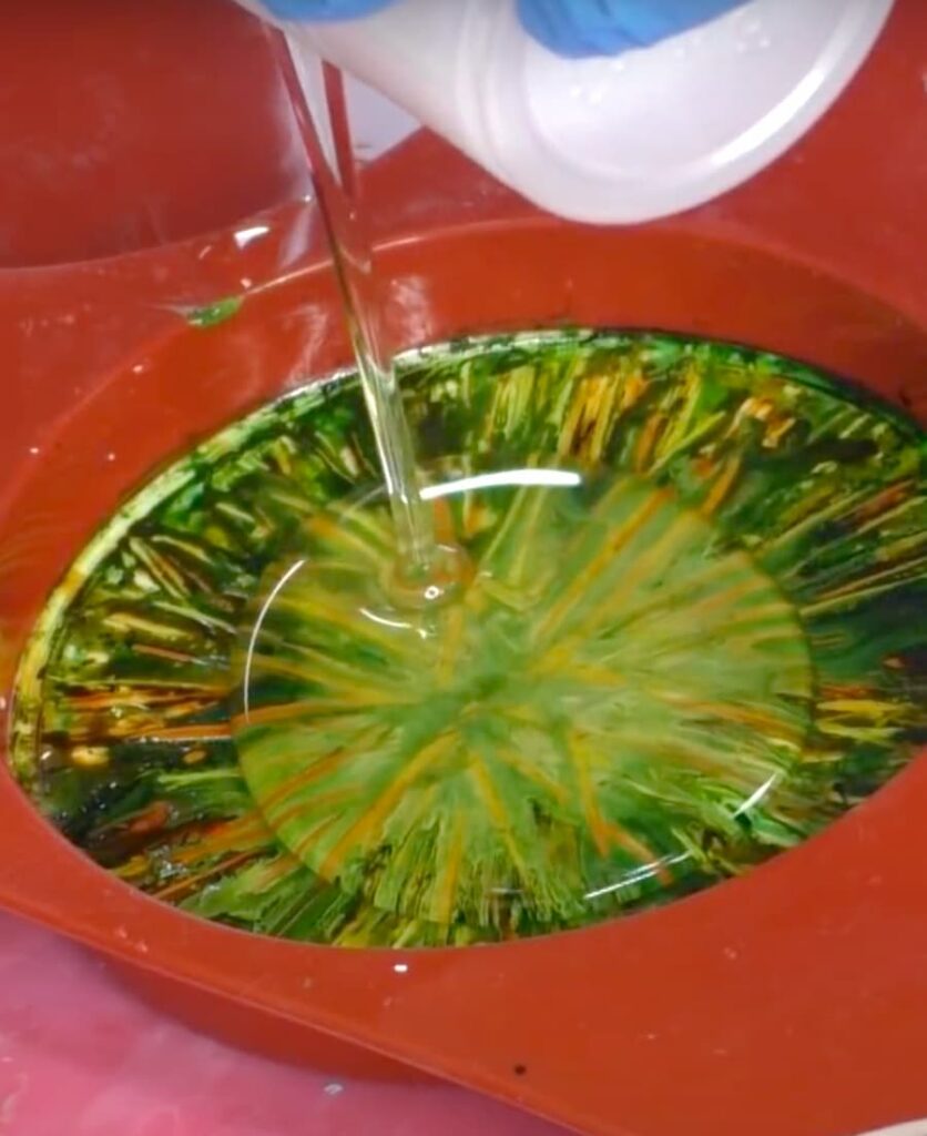 Pouring resin onto the alcohol ink coaster