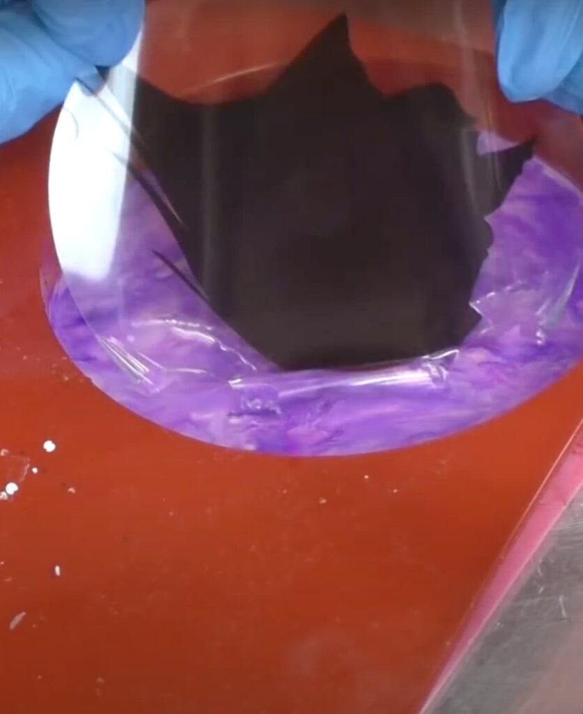 Sliding the witch silhouette into the resin coaster