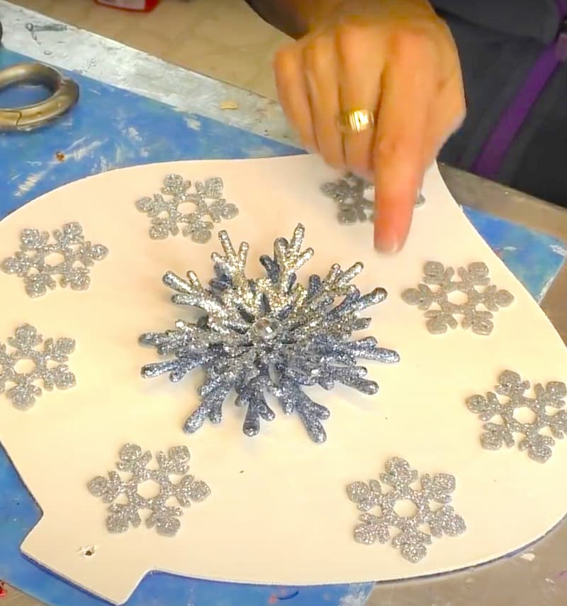 Placing snowflake on the ornament for placement