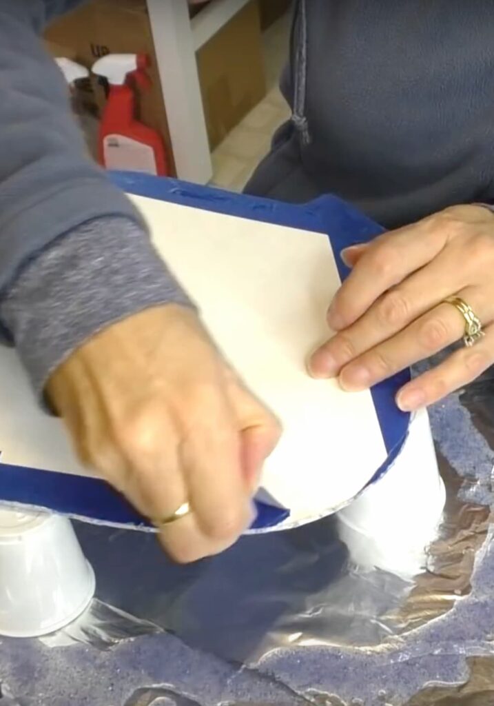 Removing the tape from the back of the snowflake craft