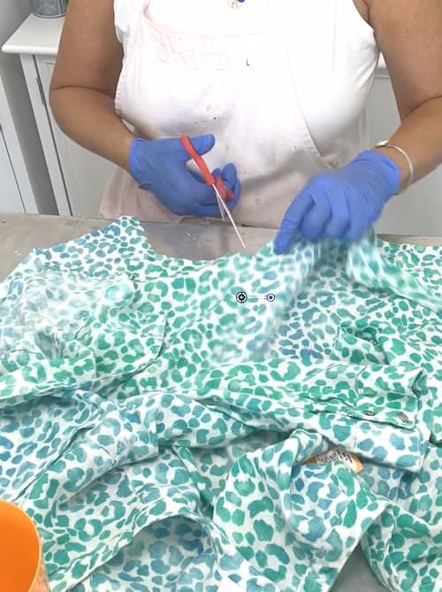 Showing how to reuse an old shirt by cutting one into pieces