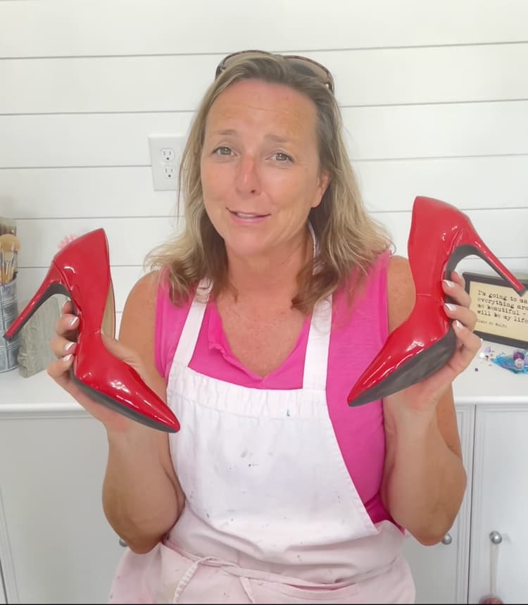 Mona holding two red high heels for high heel design transformation