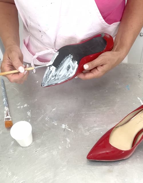 Painting Elmers Glue All to the soles of the high heel shoes