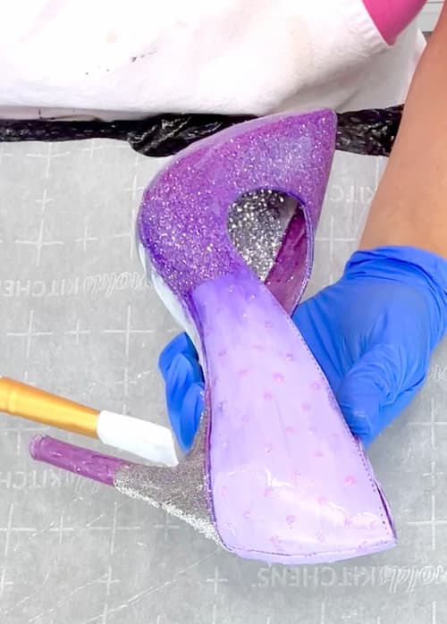 brushing resin onto purple stilettos