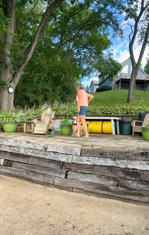 Cleaning the patio readying it for the chaise lounge beach chairs