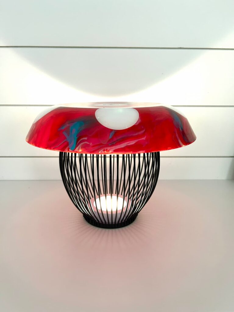 Mushroom light lit up with black candle holder