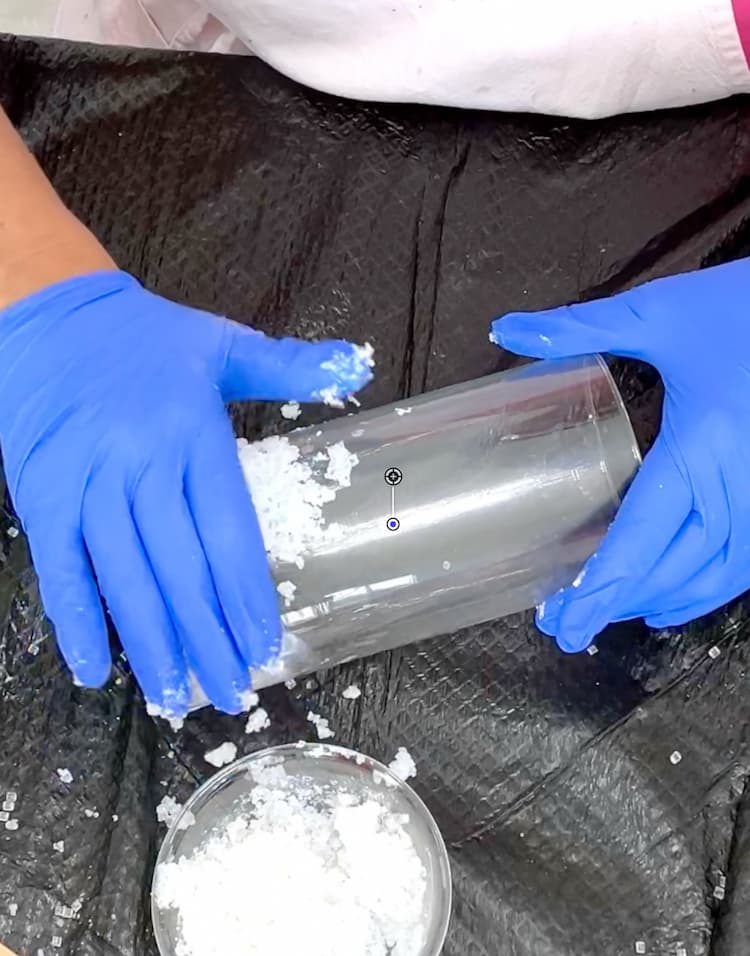 Patting salt and vase filler mixture onto to vase