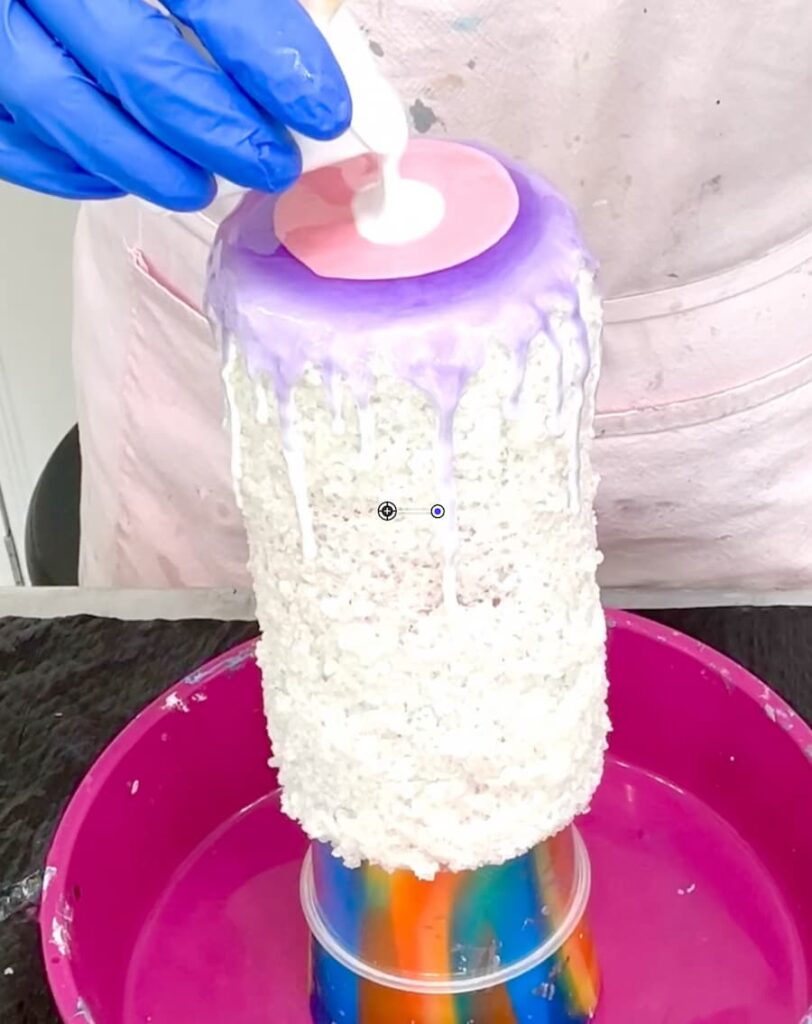 Pouring resin on the vase covered in coarse salt