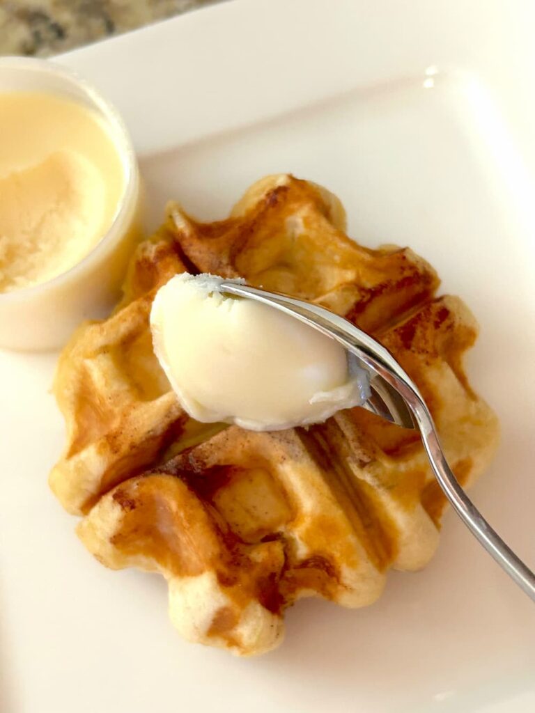 Adding icing to the cinnamon roll waffle recipe