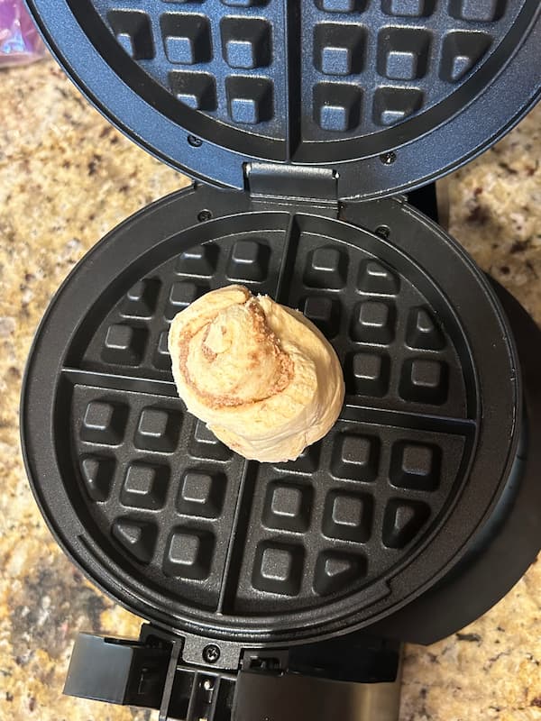 Cinnamon roll in a waffle iron