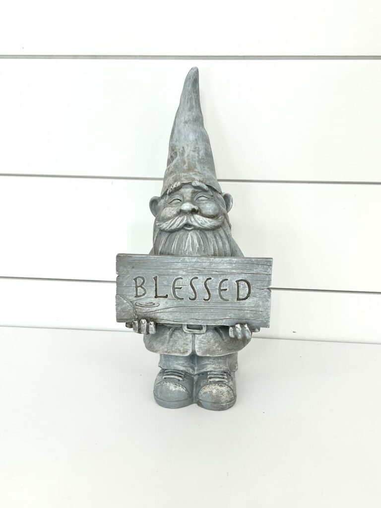 Unfinished gray fall gnome holding a blessed sign