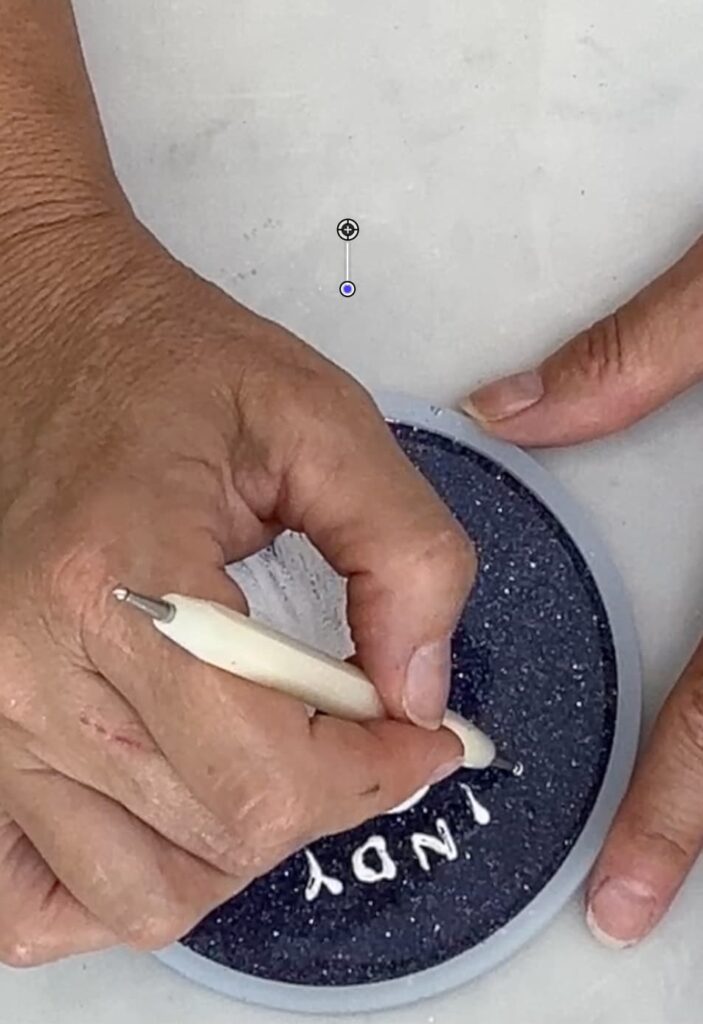 Writing a name on the painted ghost coaster