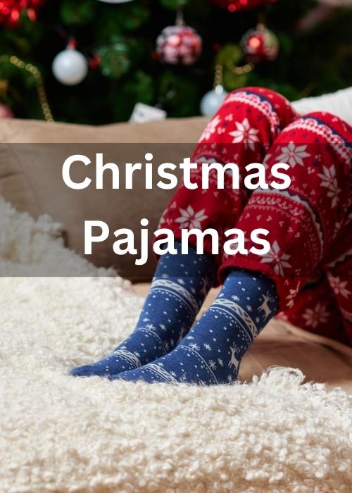 Christmas pajamas with christmas socks showing legs and feet on a fuzzy blanket