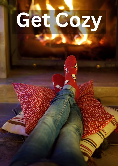 Get cozy with christmas socks and feet propped up on pillows by the fire