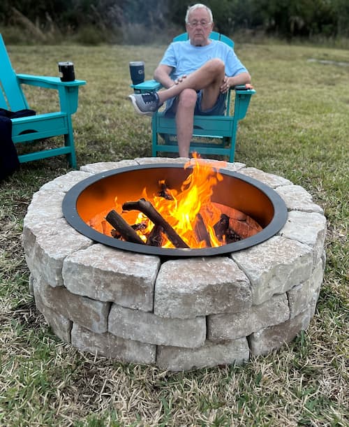 Greg sitting by the firepit