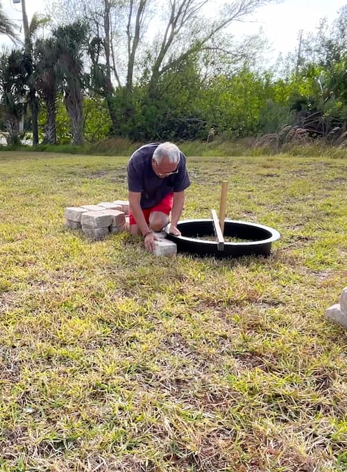 Laying bricks for the fire pit kit