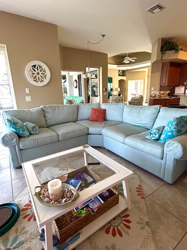 light blue sectional with off white coffee table