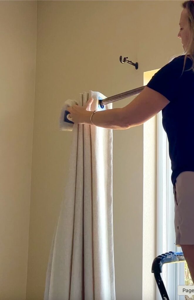 Removing curtains from the curtain rod so I can show you how to clean curtains